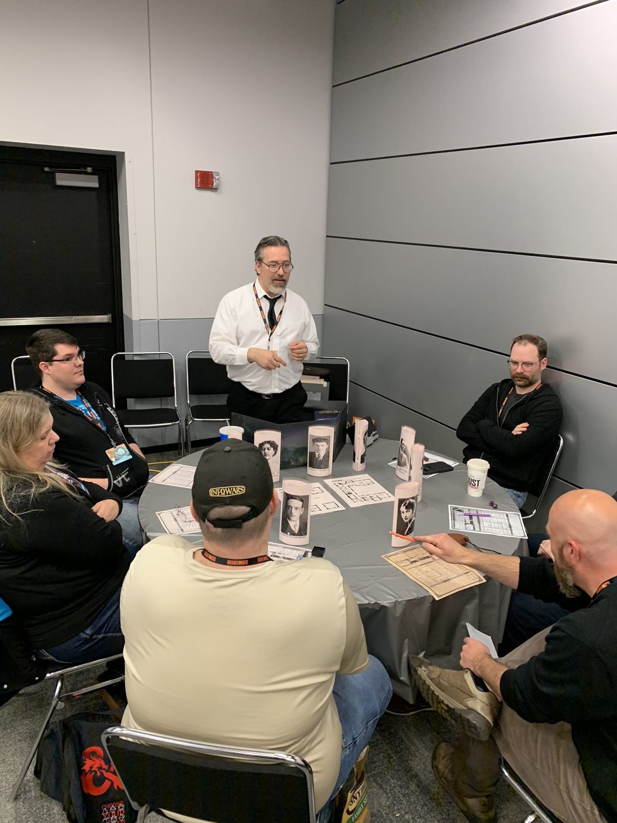 Sean standing at a convention table running Call of Cthulhu, players seated around him